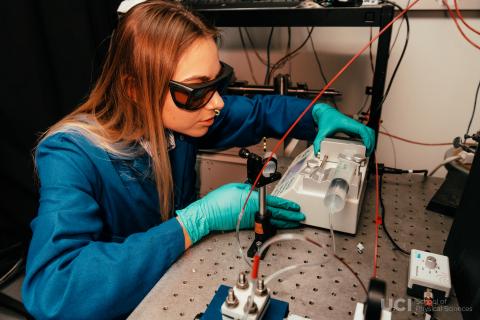 A photo of UC Irvine graduate student Anastasiya Bender working with lab equipment.